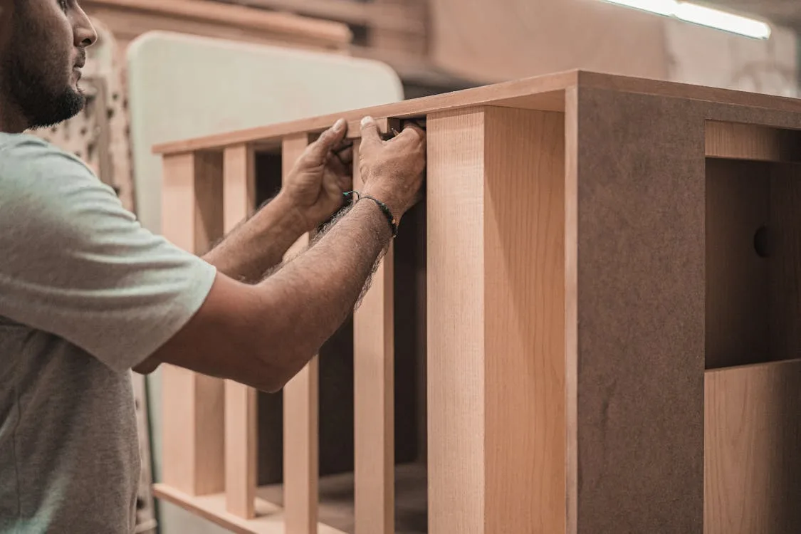 Craftsman working on bespoke woodwork detail